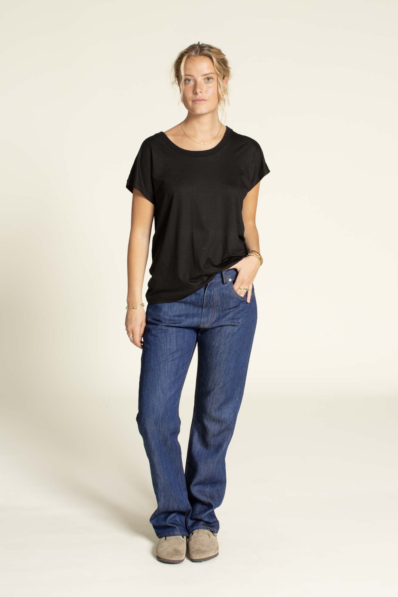 Woman wearing the Easy T-shirt sewing pattern from Wardrobe by Me on The Fold Line. A top pattern made in knit jersey or woven double gauze, silk or viscose fabric, featuring a relaxed fit, round neckline, and grown-on short sleeves.