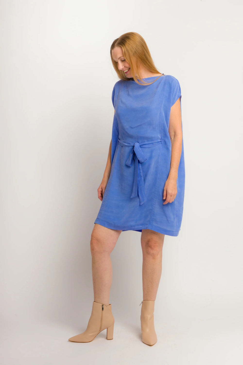 Woman wearing the Gemini Dress sewing pattern from 奥州五开奖官网开奖号 Cris Wood Sews on The Fold Line. A dress pattern made in linen, lightweight cotton, silk, rayon, viscose blend, gauze, or stable knit fabric, featuring a shallow funnel neckline, short grown-on sleeves, a long tie belt, and knee length.