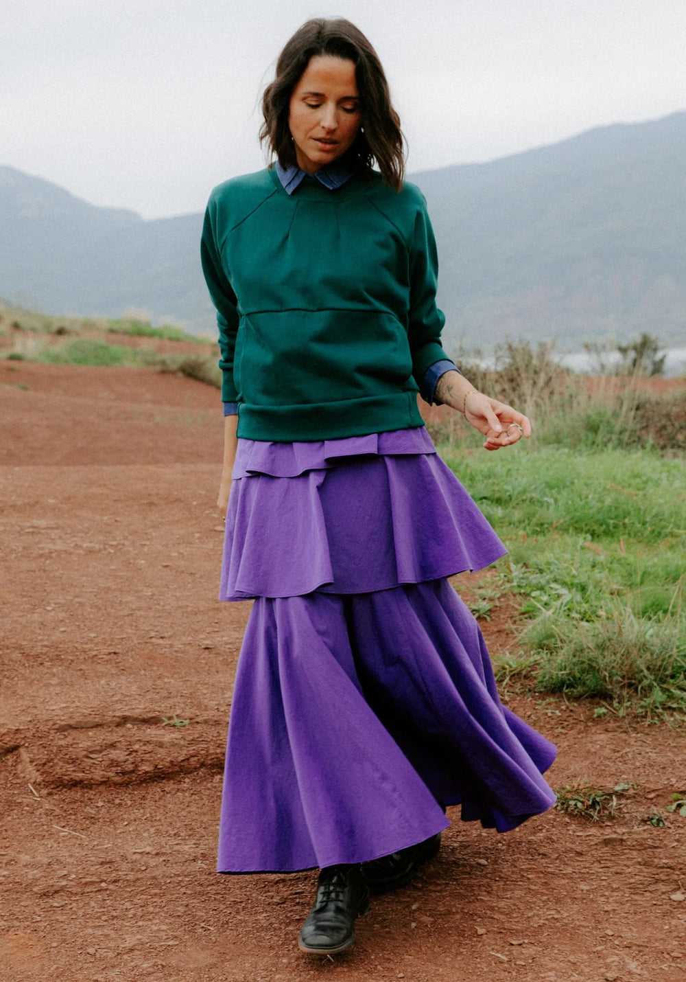 Woman wearing the Highland Skirt sewing pattern from Maison Fauve on The Fold Line. A skirt pattern made in viscose, light chambray, fine cotton satin, cotton, crepe, very fine wool, tulle or silk fabric, featuring three flounces, an invisible zip, and maxi length.
