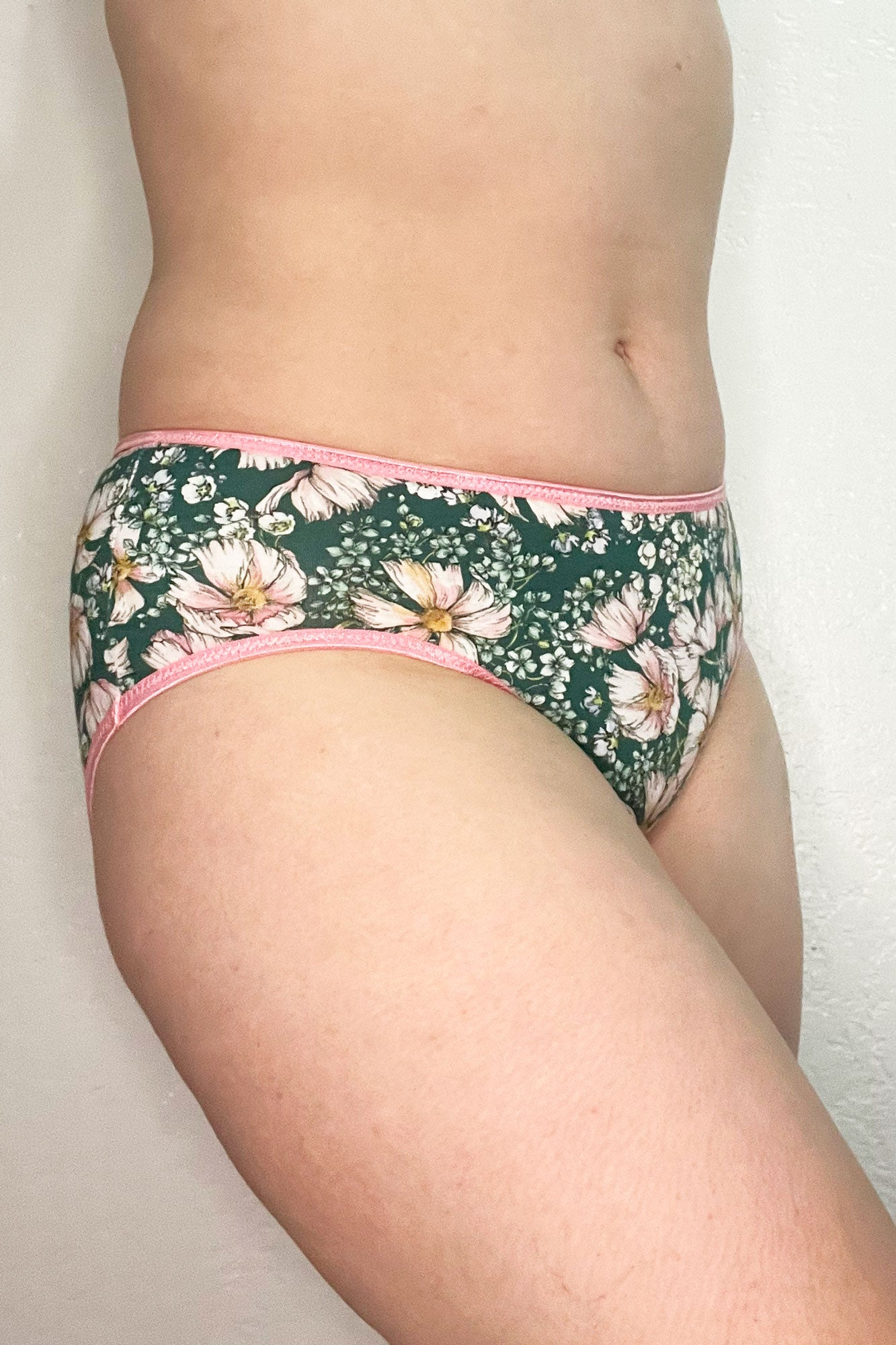 Woman wearing the Orla Briefs sewing pattern from Primrose Dawn on The Fold Line. An underwear pattern made in stretch knit fabric, featuring a low rise, elastic waist, slightly high-cut leg openings finished with fold over elastic, and a full coverage back.