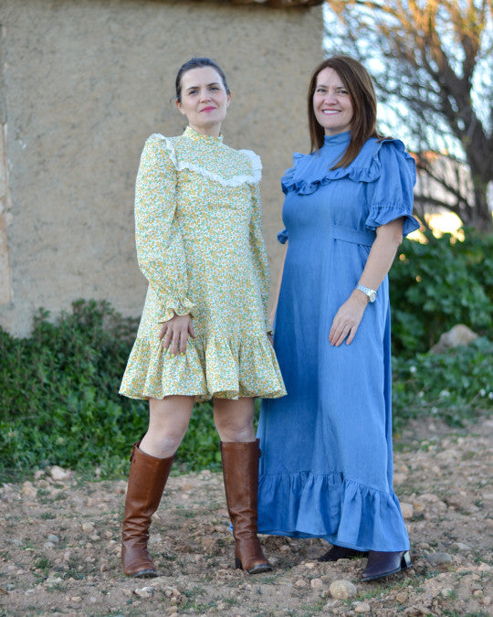 Women wearing the Sorolla Dress sewing pattern from Pauline Alice on The Fold Line. A dress pattern made in poplin, cotton lawn, chambray, viscose, linen, or flannel fabric, featuring a stand collar, yokes finished with frills, princess seams, waist ties, short or long sleeves gathered with elastic, a hem frill, and mini or maxi length.