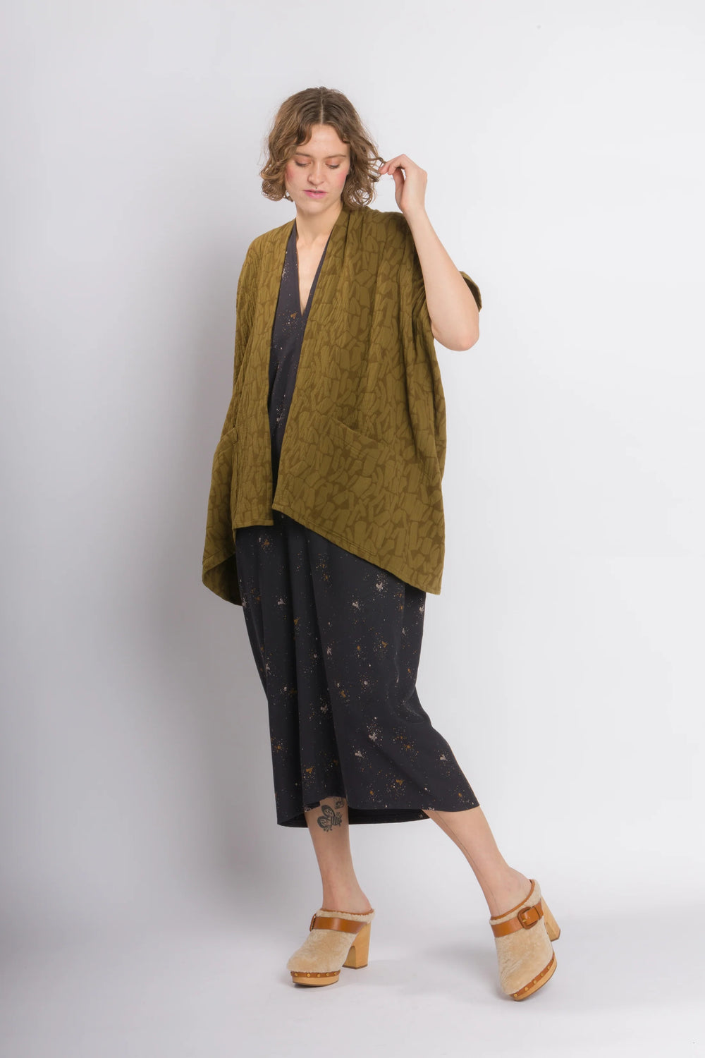 Woman wearing the Throw Jacket sewing pattern from Cris Wood Sews on The Fold Line. A jacket pattern made in linen, lightweight cotton, silk, rayon, viscose blend, gauze, ponte, cotton jacquard, or french terry fabric, featuring an oversized silhouette, patch pockets, and fully enclosed seams.
