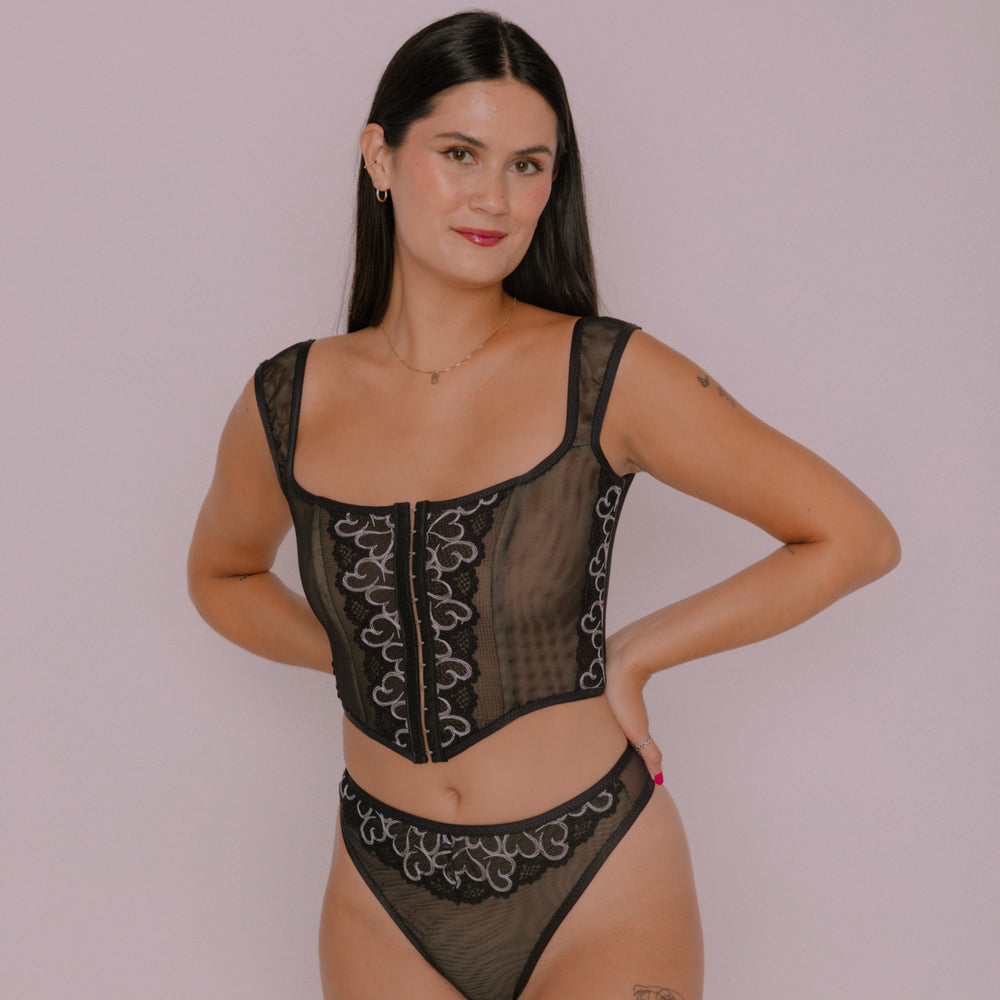 Woman wearing the Free Odessa Corset Top and Panty sewing pattern from Madalynne on The Fold Line. A corset top and panty pattern made in stretch mesh, stretch all over lace, jersey, and lycra fabrics, featuring fold over elastic, channelling, plastic bon